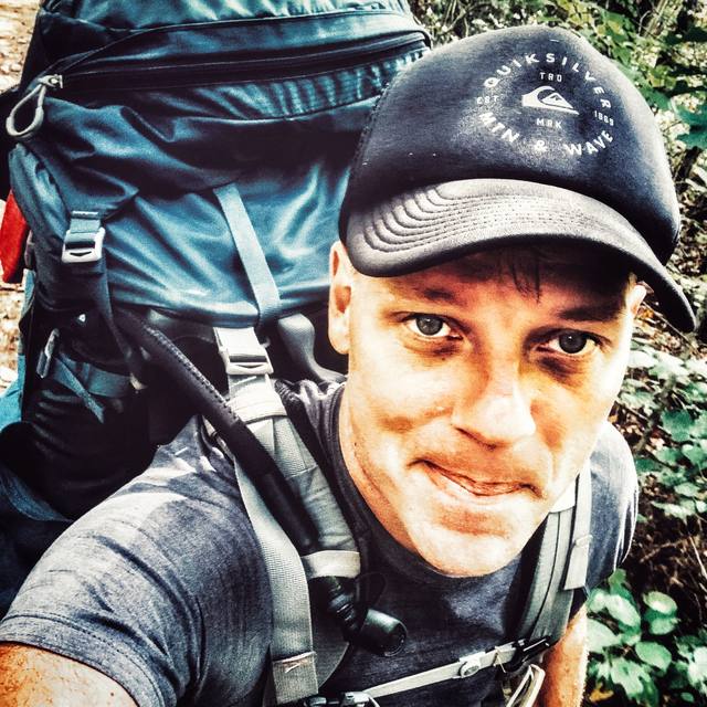 Daniel Bennett backpacking in the mountains