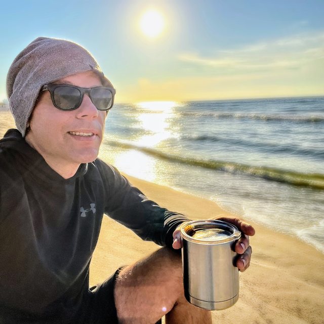 Daniel Bennett making coffee beside the water