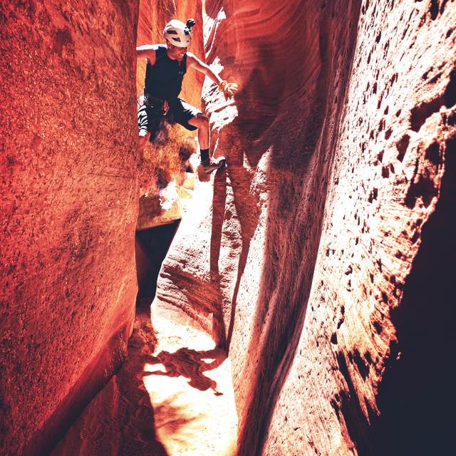 Daniel Bennett hiking through a slot canyon